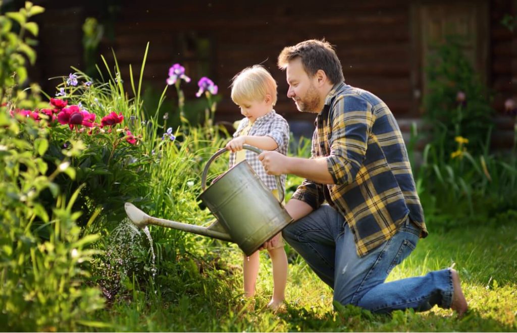 Father outside gardening with his daughter